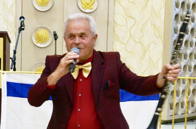 Audience members, many in traditional lace head coverings and elegant Bukharian hats, clap along with familiar melodies from across the FSU.