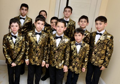 The Bukharian Boys Choir performs with youthful spirit in their signature black-and-gold jackets, delighting the multigenerational audience at Ohr Natan.